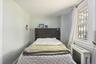 Bright bedroom featuring ample natural light, a large window, and comfortable living space. 1st Floor.