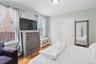 Wood-finish flooring with a flush-mounted ceiling light fixture. 1st Floor.