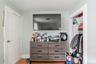 Bedroom featuring a spacious closet, hardwood floors, and ample storage space. 1st Floor.