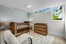 Cozy third bedroom with garden views — flexible space for guests or home office.