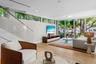 Cozy sitting space with large windows bringing in sunshine — Miami Beach indoor-outdoor lifestyle at its finest.