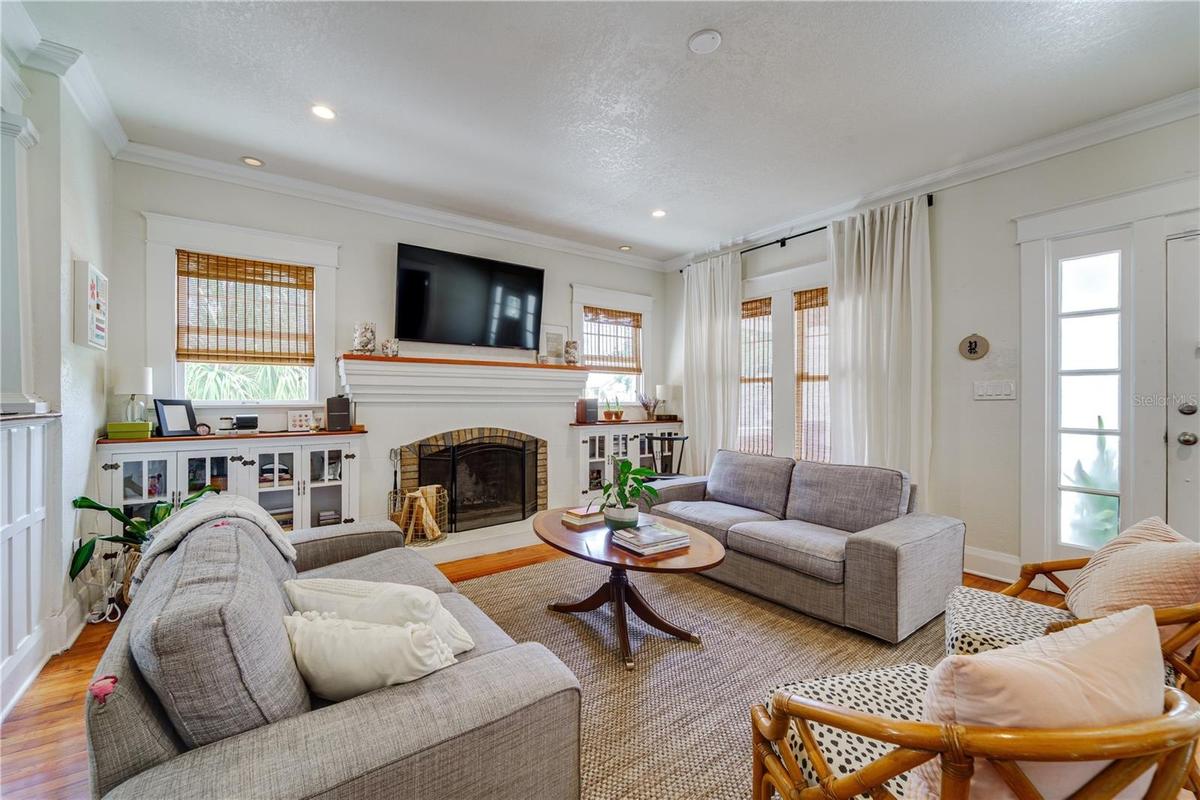 The living room is lovely. Built-ins, huge window & door casings, crown molding, and a hearty fireplace and mantel to anchor the room.