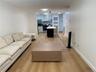 Open-concept living space featuring wood-finish flooring