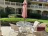 Paved patio area, manicured lawn, and established shrubbery