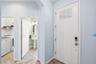 Foyer looking toward half bath and interior laundry room