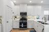 Kitchen with gas cooktop, spacious pantry.