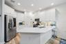 Beautiful chef's kitchen with quartz countetops, real wood cabinets and spacious pantry