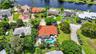 Property featuring a swimming pool, red tile roof, and mature landscaping