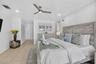 Neutral-toned tile flooring, recessed lighting, and a ceiling fan create a comfortable atmosphere