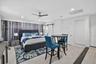 Recessed lighting, ceiling fan, sliding barn door, louvered bi-fold closet doors, and wood-finish flooring