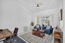 Vaulted ceiling, bay window, tile flooring, and a ceiling fan with integrated lighting