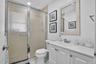 White vanity with panel cabinetry and a light-toned countertop
