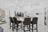 Kitchen featuring a breakfast bar with stone countertop, white cabinetry, stainless steel appliances, and recessed lighting