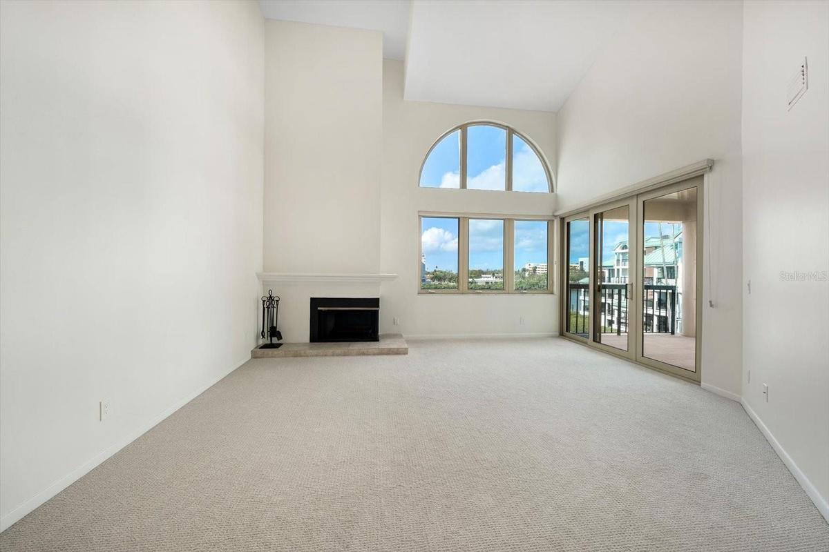 Spacious living room with soaring ceilings and fabulous natural light. Facing west, perfect for enjoying sunsets over the water.