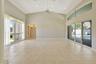 Living room with vaulted ceilings and large impact windows