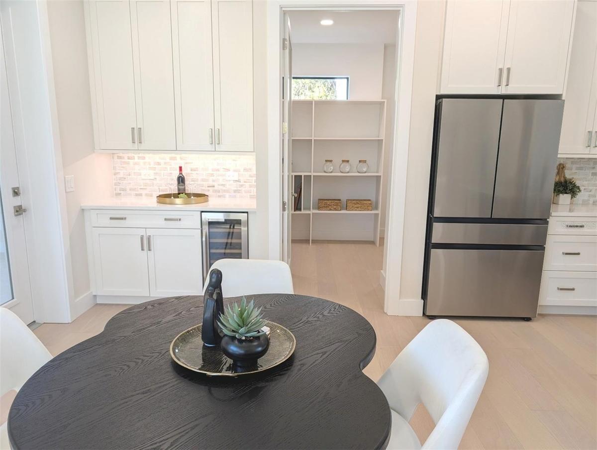 Coffee bar; spacious walk in pantry; under cabinet lighting; beverage cooler.