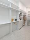 Two spacious walk in closets with custom shelving