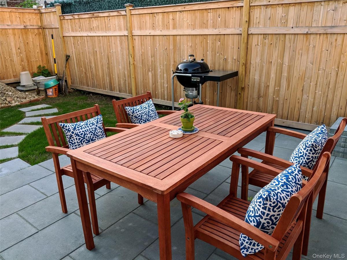 Backyard with bluestone pavers and grassy area