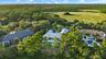 Multiple residences featuring private swimming pools and surrounding lush landscaping