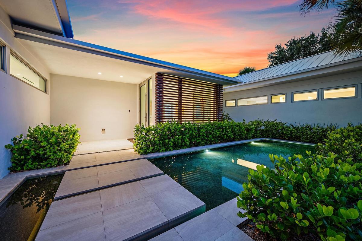 Modern exterior architecture with a metal roof and linear windows
