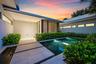 Modern exterior architecture with a metal roof and linear windows