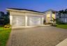 Large three car garage with finished floor, cabinets and overhead storage