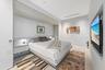Integrated headboard with built-in side tables, recessed lighting, and upper cabinetry