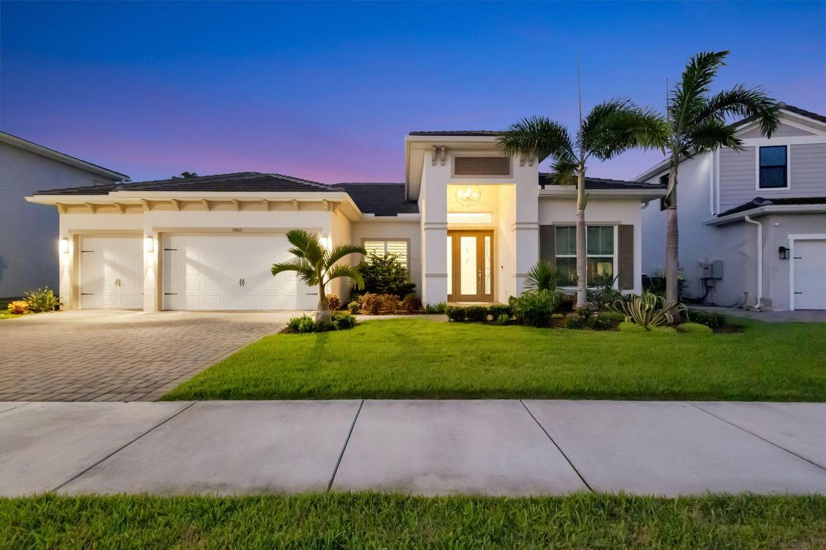 Lovely front view with custom landscaping, lighting