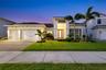 Lovely front view with custom landscaping, lighting