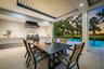 Outdoor living space featuring a built-in grill, range hood, and a flat-panel ceiling