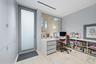 Built-in desk with three drawers, integrated shelving, and wood-finish flooring