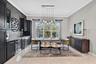 Custom Bar with large pull out pantries each side and custom wine/beverage cooler and additional dining area for entertaining.