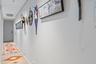 Recessed ceiling lighting, light gray wall finishes, and a light-colored wood-finish floor