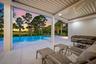 Covered outdoor patio with a corrugated ceiling, recessed lighting, and an integrated ceiling fan