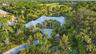Expansive property featuring lush, mature landscaping and a metal roof