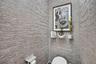Lovely primary water closet with bidet toilet and custom Italian wallpaper and chandelier
