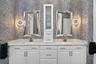 Large double vanity with quartz tops with double vanities, custom mirrors, lighting, faucets and Italian wallpaper.