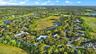Expansive residential area with numerous single-family homes, surrounding a large open green space