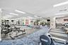 Fitness center featuring extensive cardio equipment, weight training machines, free weights, and mirrored walls