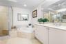 Double Sinks, glass enclosed shower with sitting bench