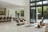 Double-height ceilings, glass paneled mezzanine railing, tile flooring, recessed lighting, and a solid wood front door