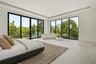 Family room with floor to ceiling windows and views of lush greenery