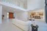 Double height great room with floor to ceiling glass overlooking the pool