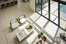 Seamless flow between living, dining, and entry beneath dramatic ceiling heights