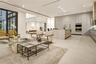 Double-height ceilings with floor-to-ceiling black-framed windows, expansive glass sliding doors, large-format tile flooring, recessed lighting, and b