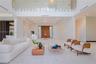 Light filled living area with soaring ceilings and walls of glass to the backyard