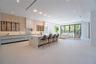 Dining space with seating for ten, set beneath a sleek coffered ceiling