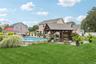 Semi In-Groud Pool Highlights the Vibrant Landscaping and Deck Surrounding