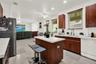 Neutral-toned tile flooring, white wall finish, single-hung window with a blind, and a central ceiling fan