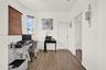 Wood-finish flooring, ceiling fan, dual windows with multi-pane and sliding configurations, and double-door reach-in closet